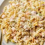 cold shrimp pasta salad in a shallow serving bowl