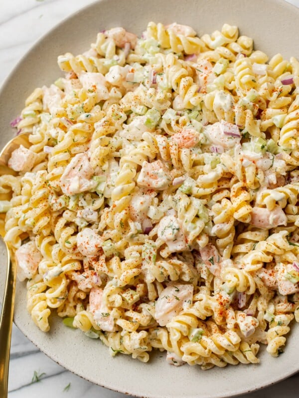 cold shrimp pasta salad in a shallow serving bowl