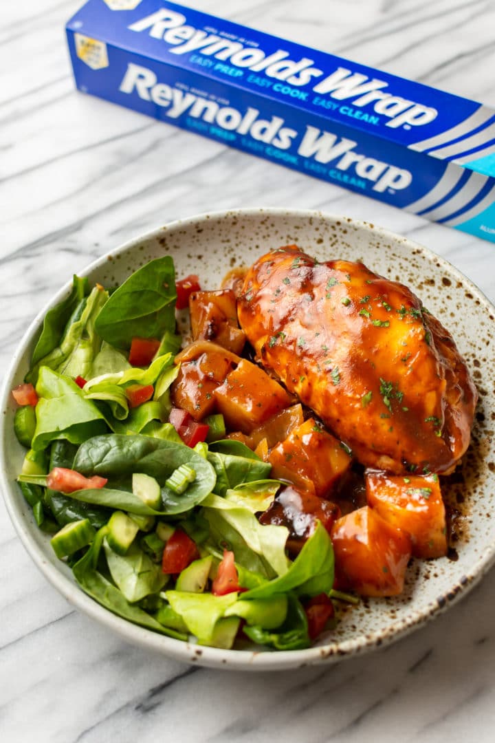 BBQ Chicken Foil Packet plated in a shallow bowl with Reynolds Wrap Foil on the side