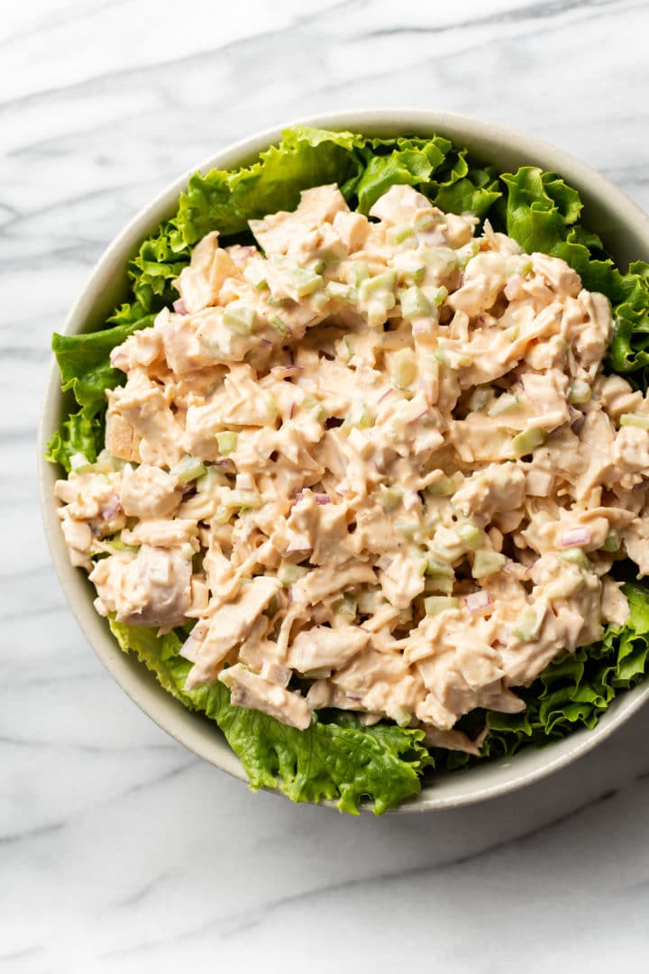 buffalo chicken salad plated on a bowl of lettuce