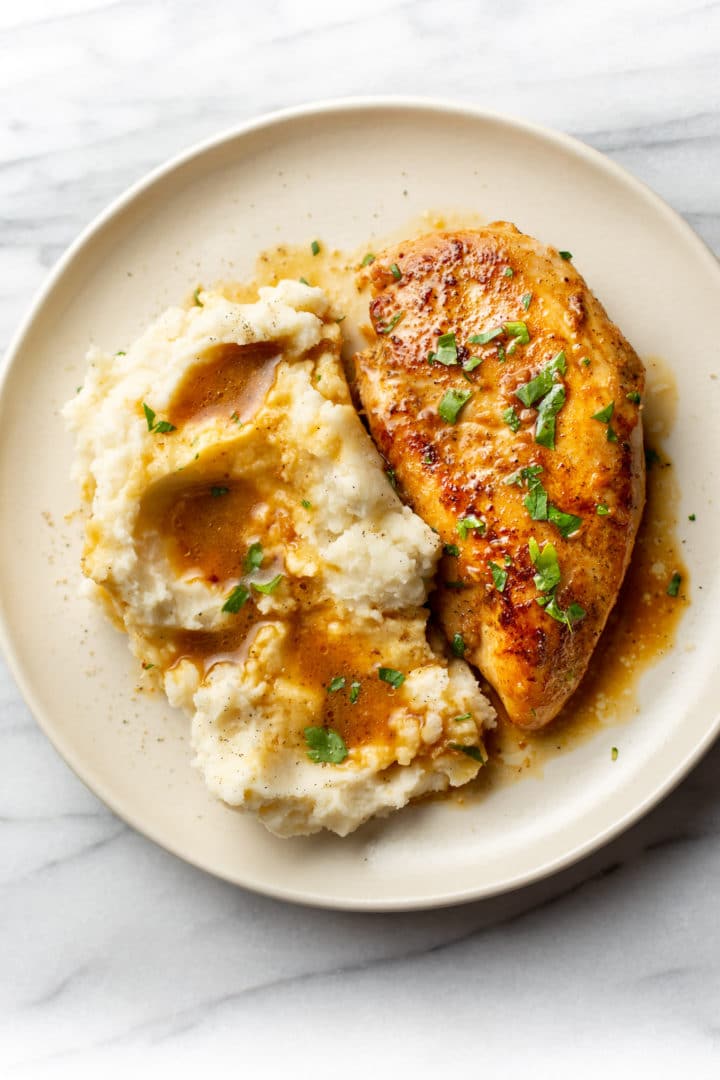 Cajun garlic butter chicken plated with mashed potatoes