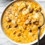 cheesy sausage potato soup in two white bowls