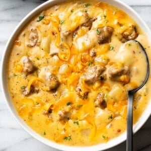 cheesy sausage potato soup in two white bowls