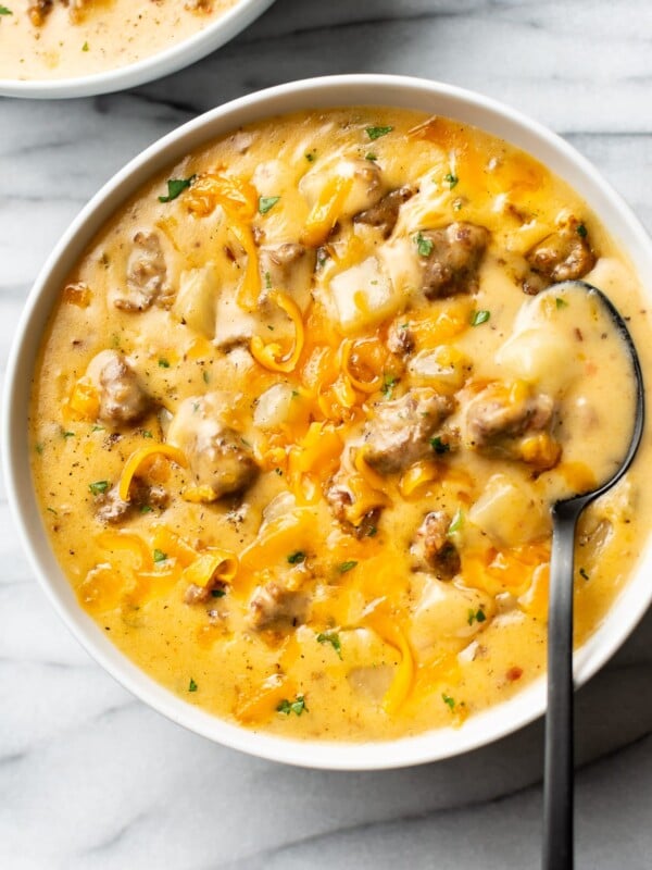 cheesy sausage potato soup in two white bowls