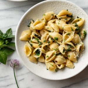 herb butter pasta in two white bowls