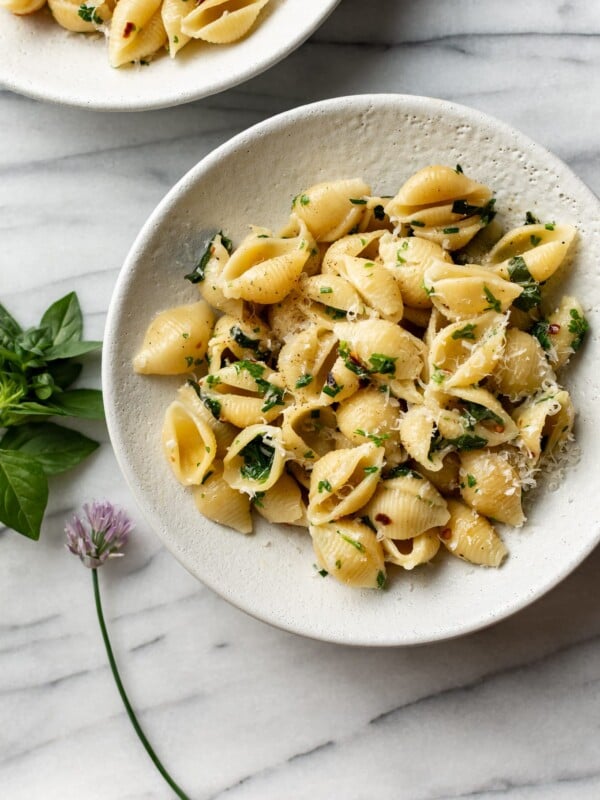 herb butter pasta in two white bowls