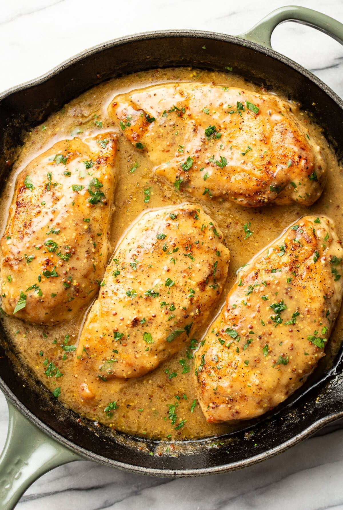 a skillet with honey mustard chicken