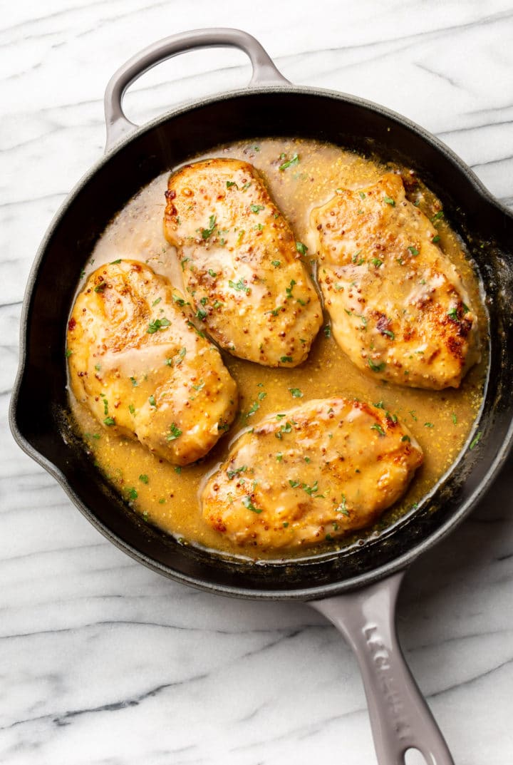 easy honey mustard chicken in a cast iron skillet