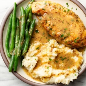 a plate with honey mustard chicken, green beans, and mashed potatoes