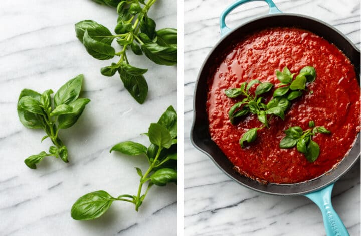 adding basil sprigs to a cast iron skillet with marinara sauce