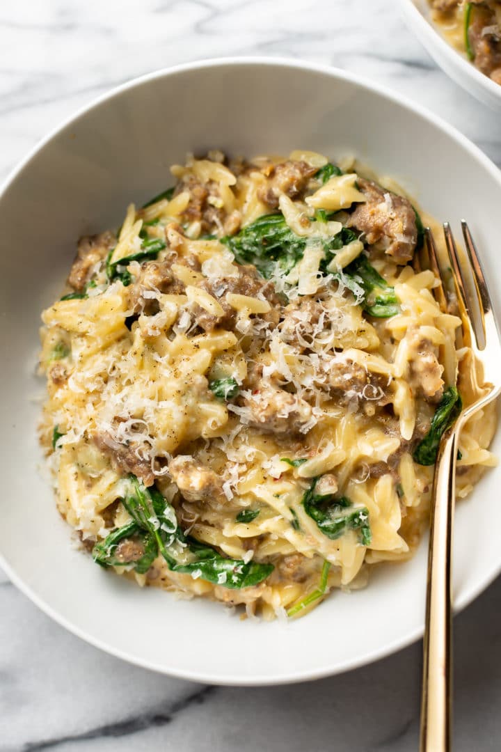 one pot orzo with Italian sausage in a white bowl