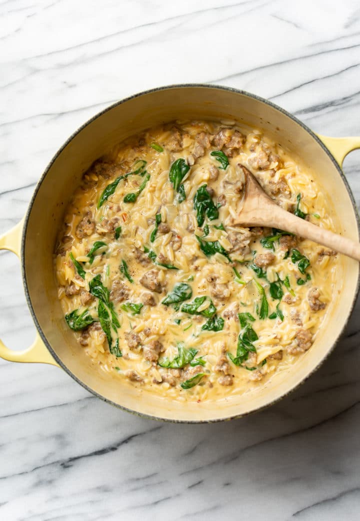 Italian sausage orzo in a yellow pot