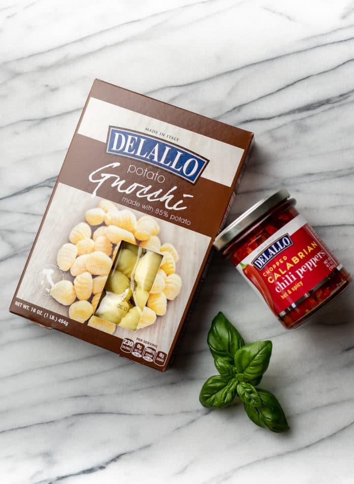 DeLallo potato gnocchi package and a jar of DeLallo chopped calabrian chili peppers in a jar