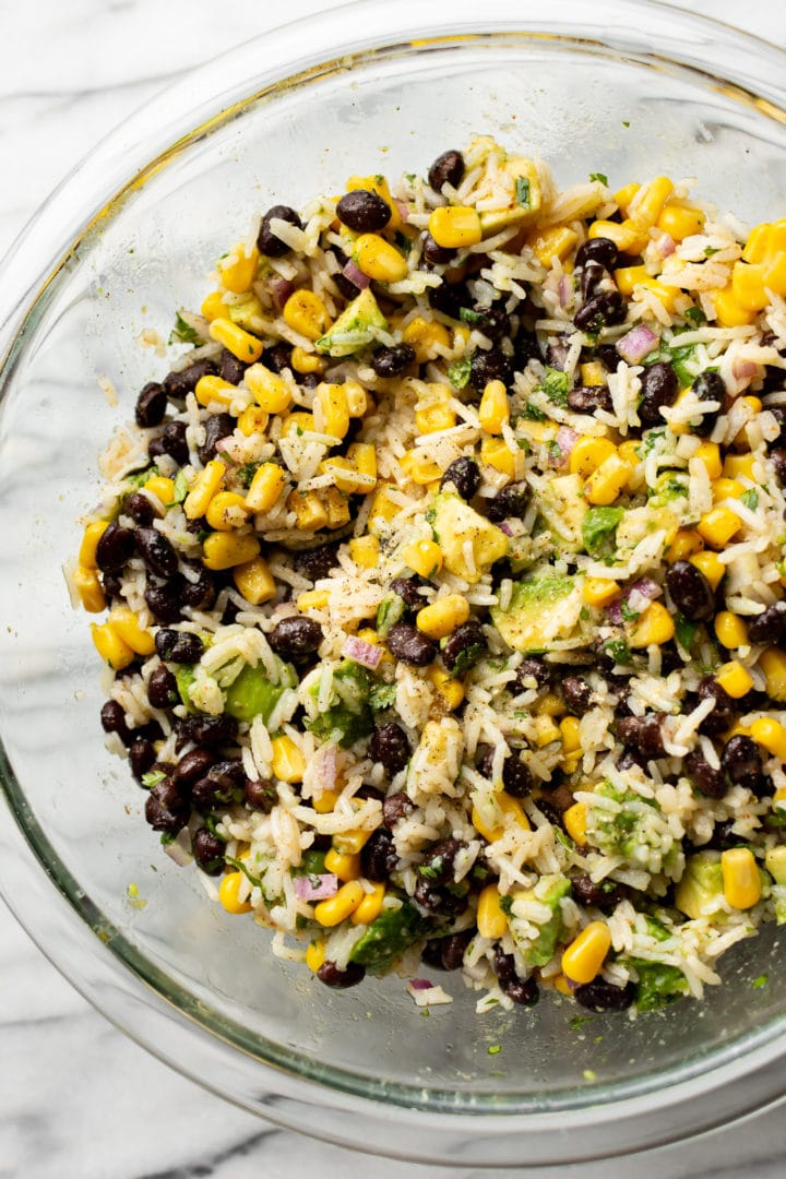 close-up of black bean, corn, avocado salad in a glass prep bowl