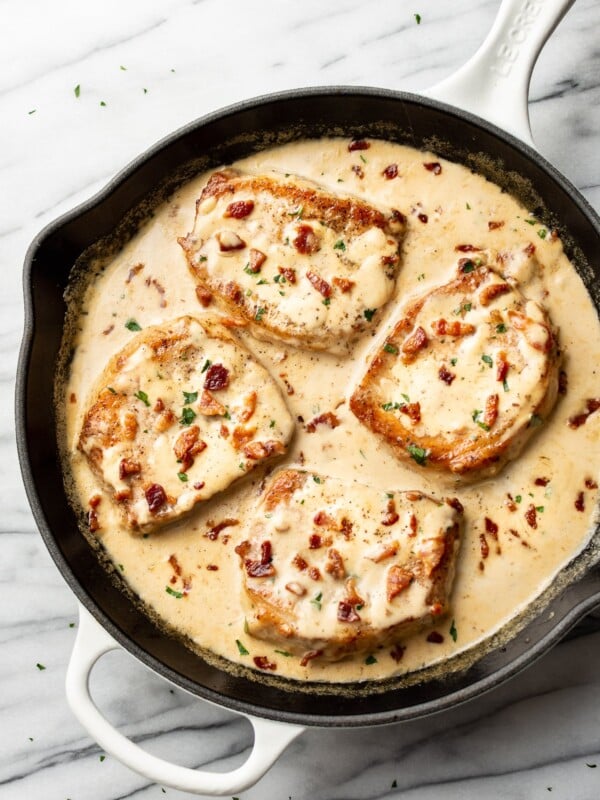 creamy bacon pork chops in a skillet