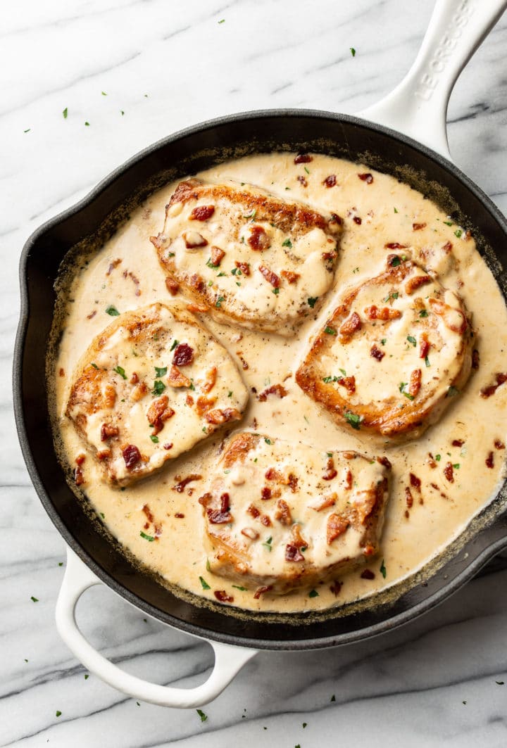 creamy bacon pork chops in a skillet