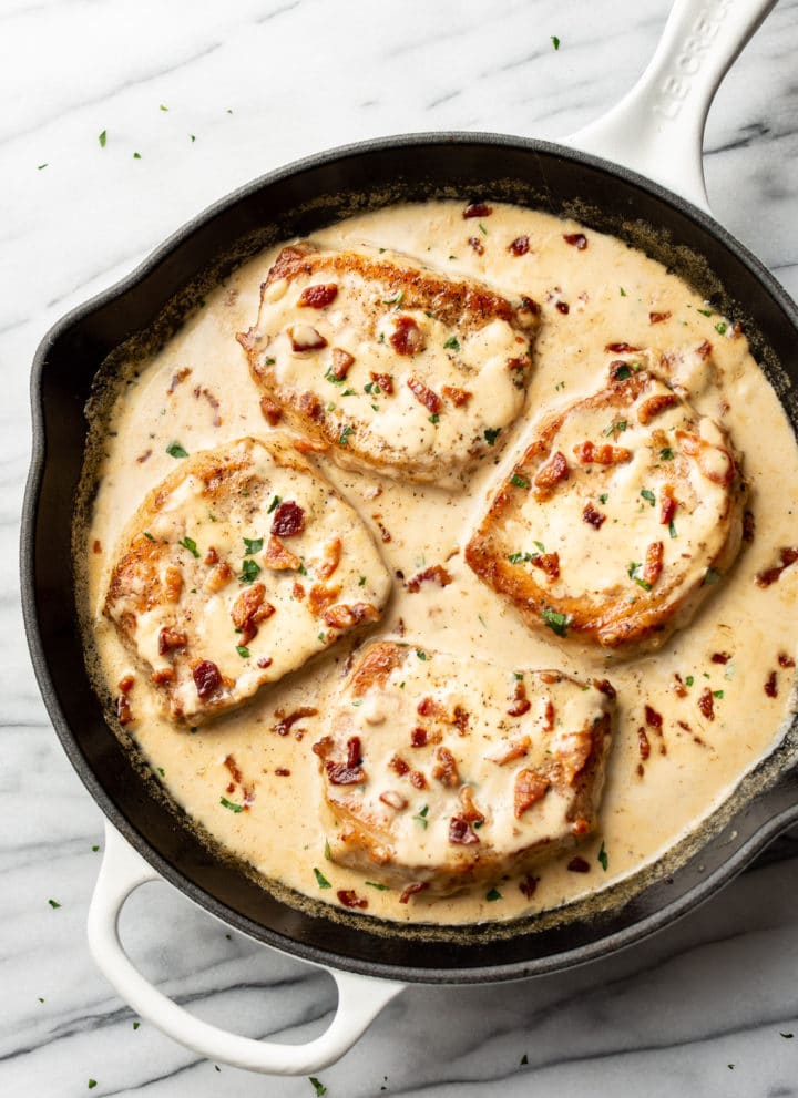 creamy bacon pork chops in a skillet