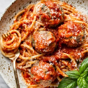 close-up of the best homemade meatballs plated with pasta