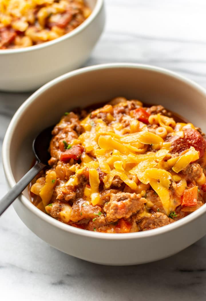 American goulash in a bowl with a spoon