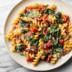 BLT pasta on a beige plate