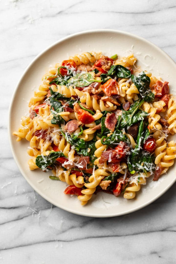 BLT pasta on a beige plate