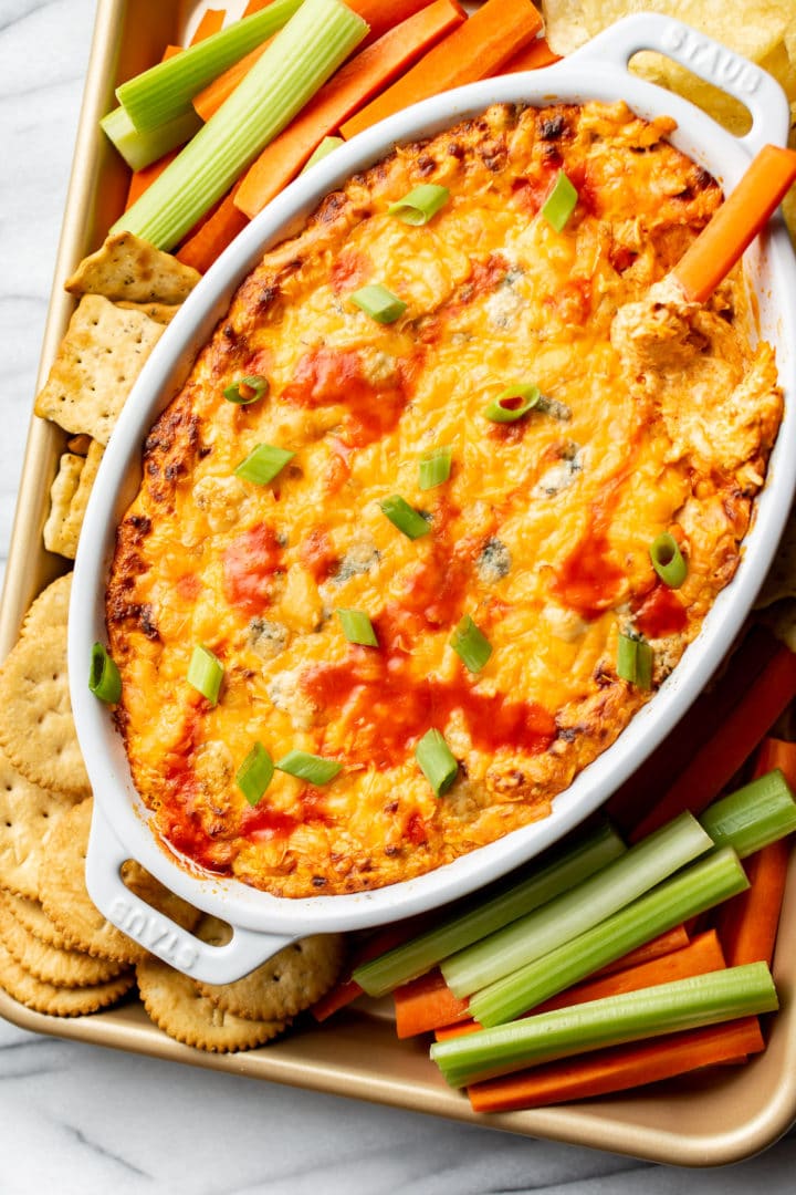 buffalo chicken dip surrounded by veggies, crackers, and chips