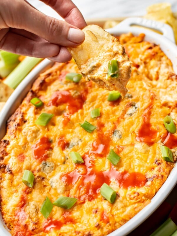 a chip being dipped into hot buffalo chicken dip