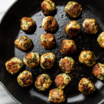 skillet filled with chicken spinach meatballs