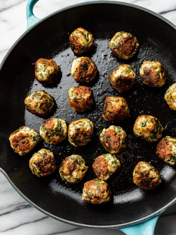 skillet filled with chicken spinach meatballs