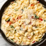 close-up of creamy tomato basil pasta in a skillet