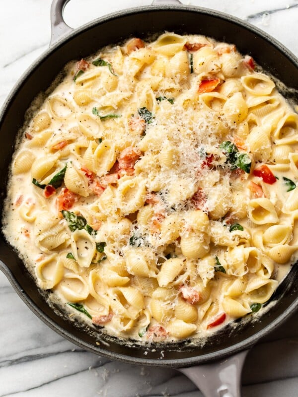 close-up of creamy tomato basil pasta in a skillet