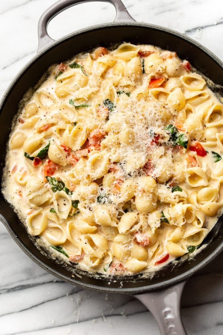 close-up of creamy tomato basil pasta in a skillet