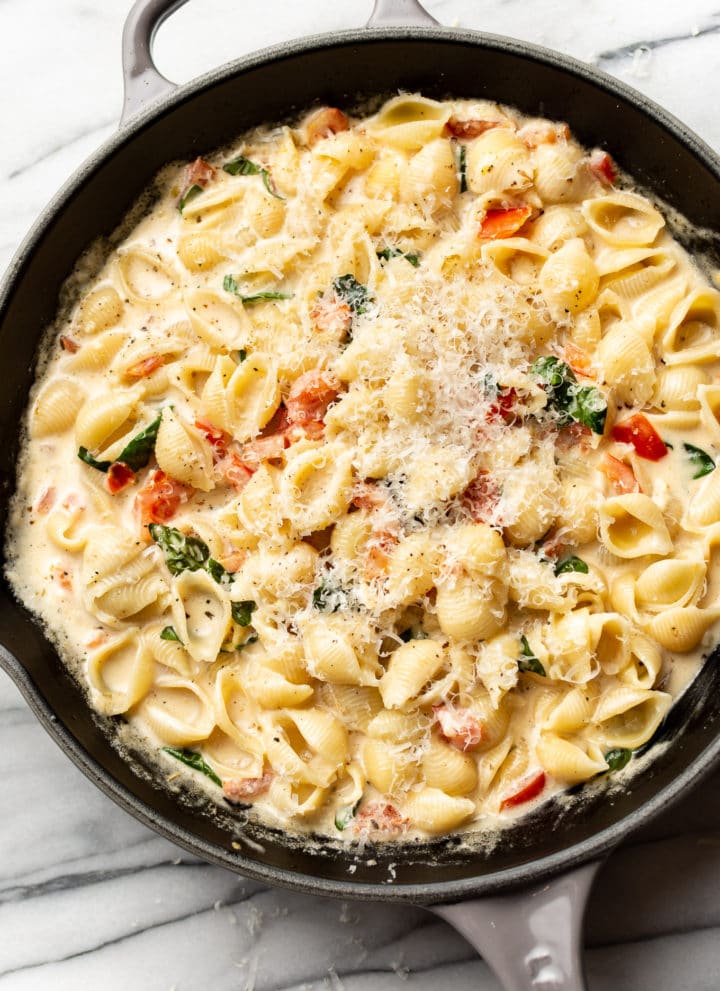 close-up of creamy tomato basil pasta in a skillet