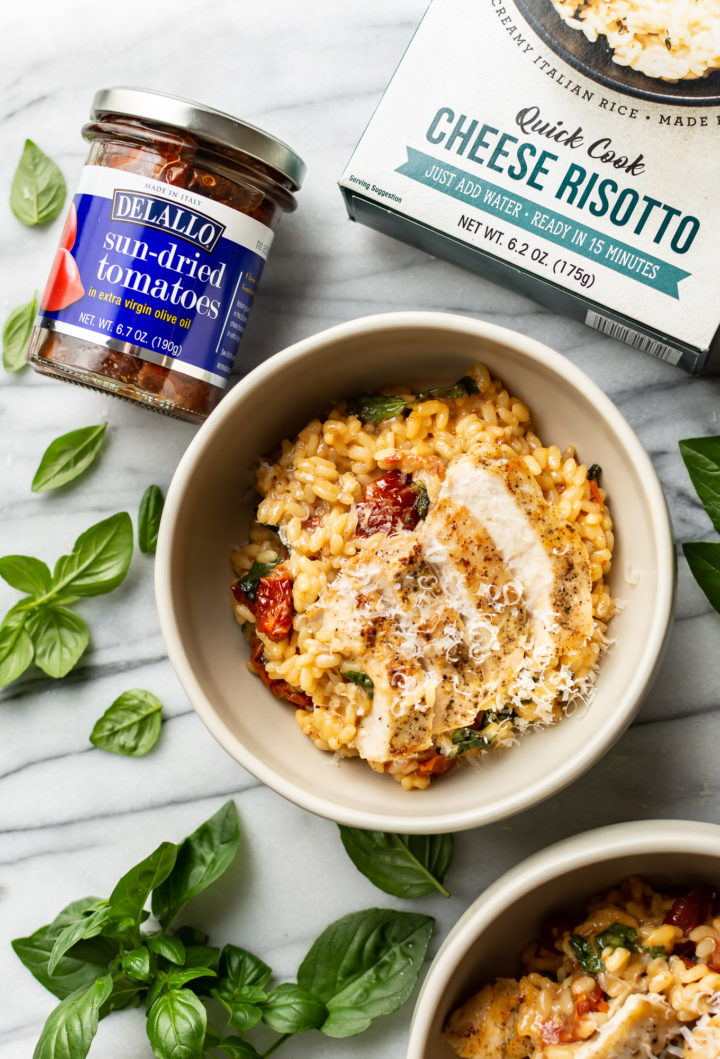 easy risotto with chicken and sun-dried tomatoes in two bowls with package of DeLallo's Quick Cook Risotto and jar of DeLallo sun-dried tomatoes
