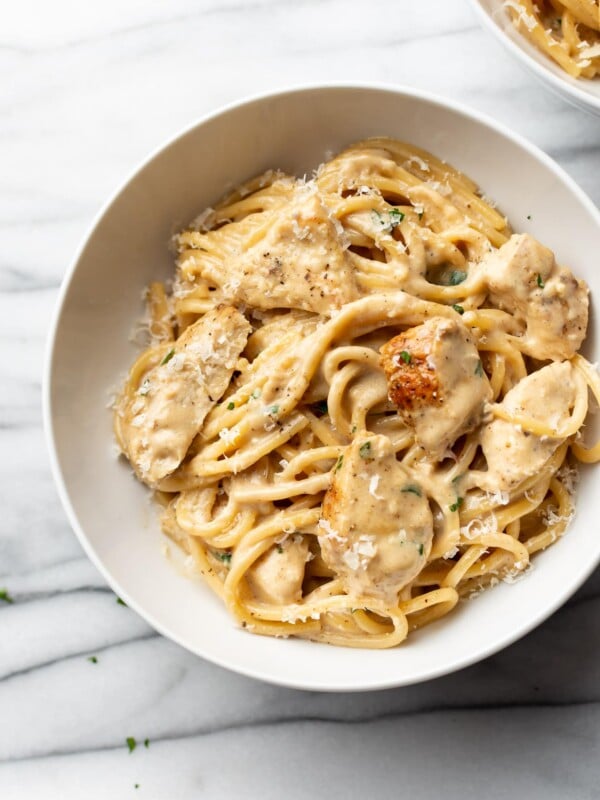 creamy garlic chicken pasta in a white bowl