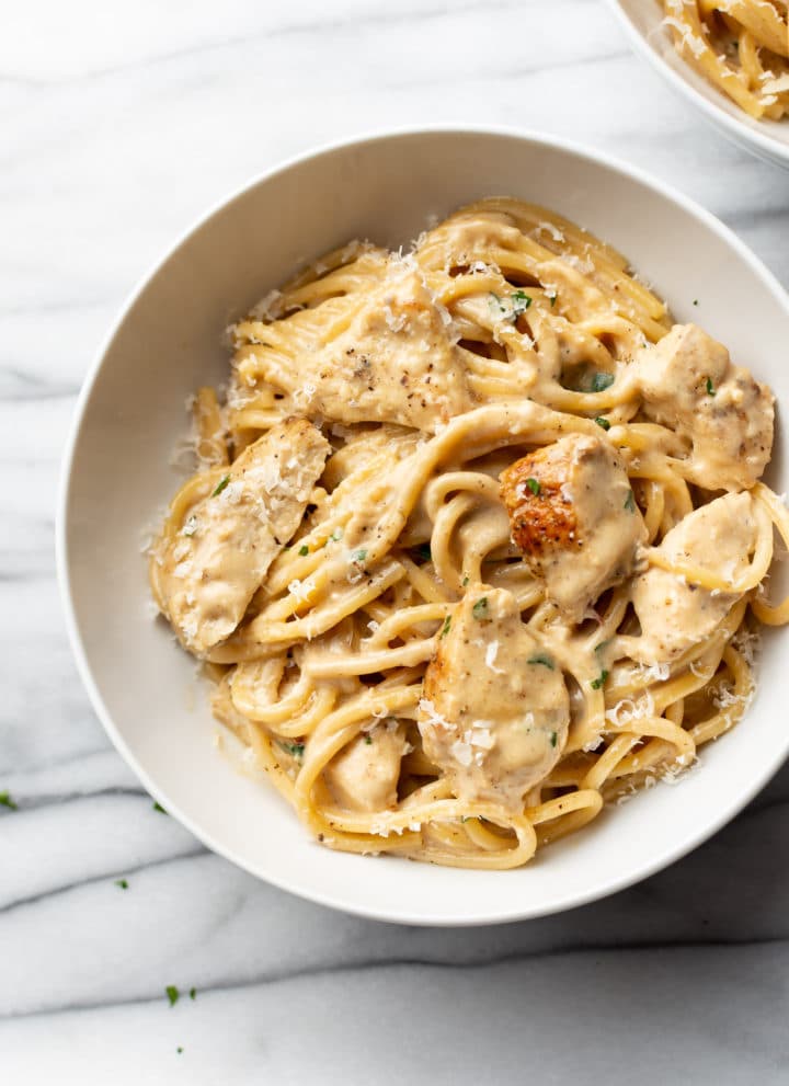 creamy garlic chicken pasta in a white bowl