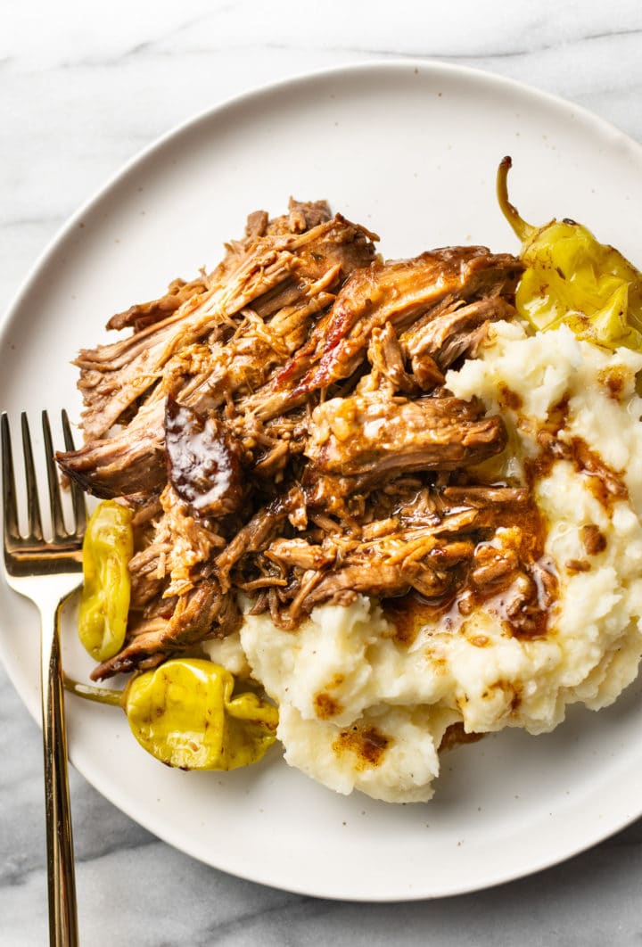 Mississippi pot roast on a plate with mashed potatoes