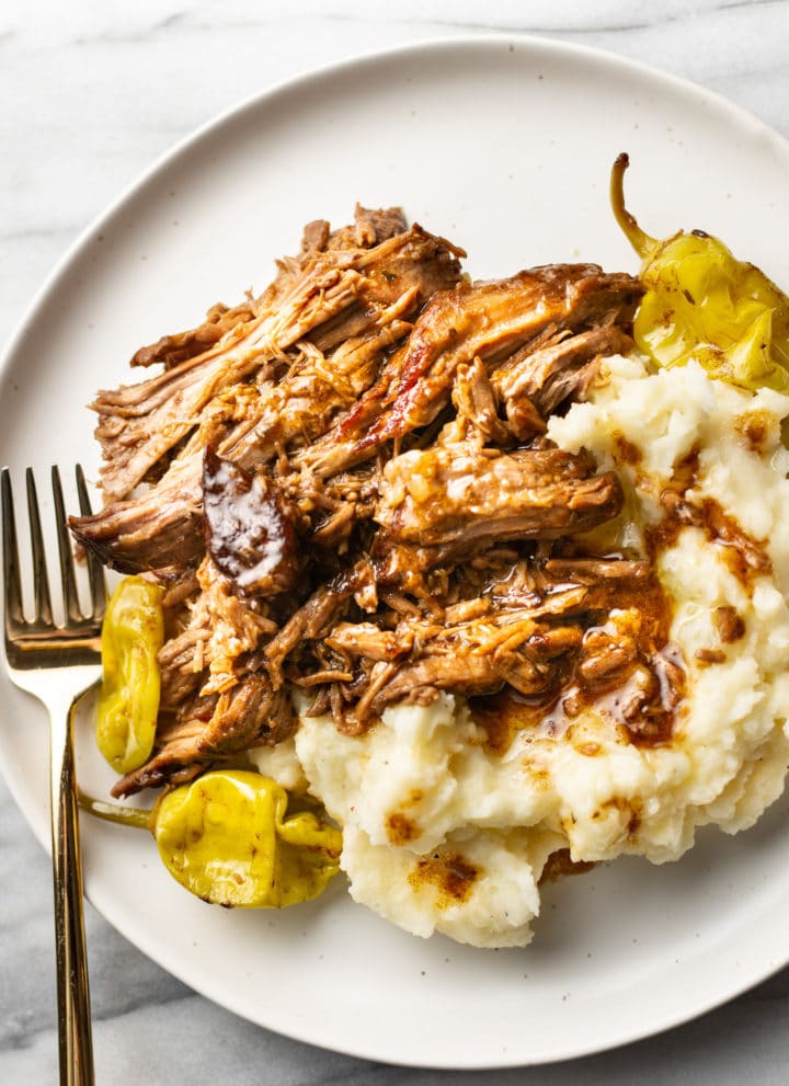 Mississippi pot roast on a plate with mashed potatoes