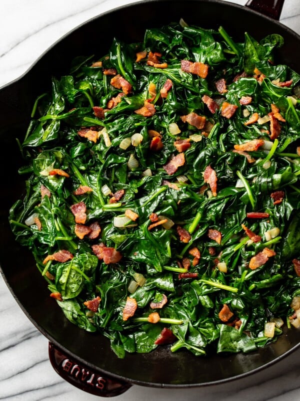 sauteed spinach with bacon in a cast iron skillet