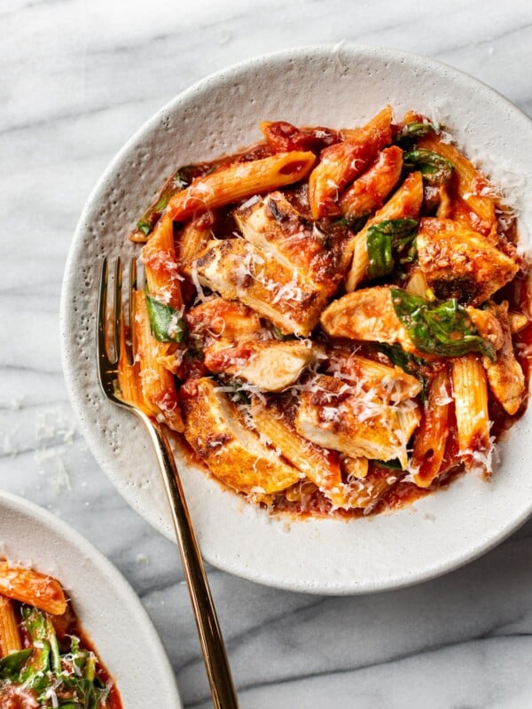 spicy chicken pasta in two shallow bowls