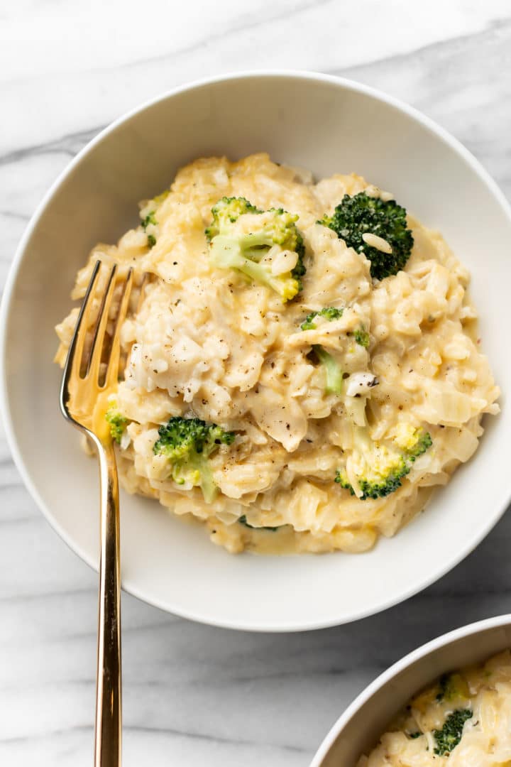 chicken broccoli and rice in two white bowls