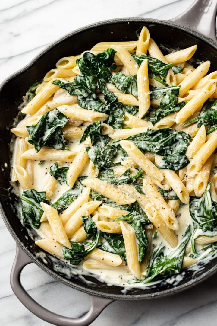 creamy spinach pasta in a skillet