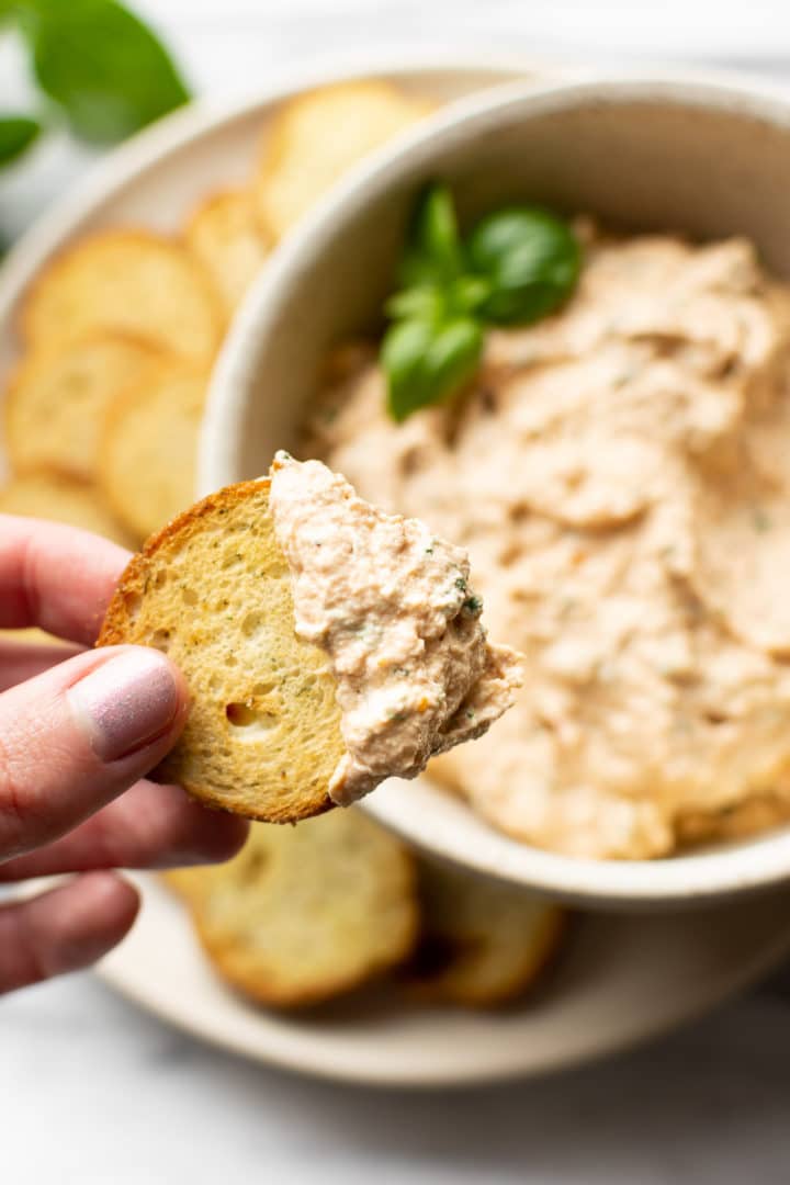 whipped goat cheese dip on a toasted baguette slice