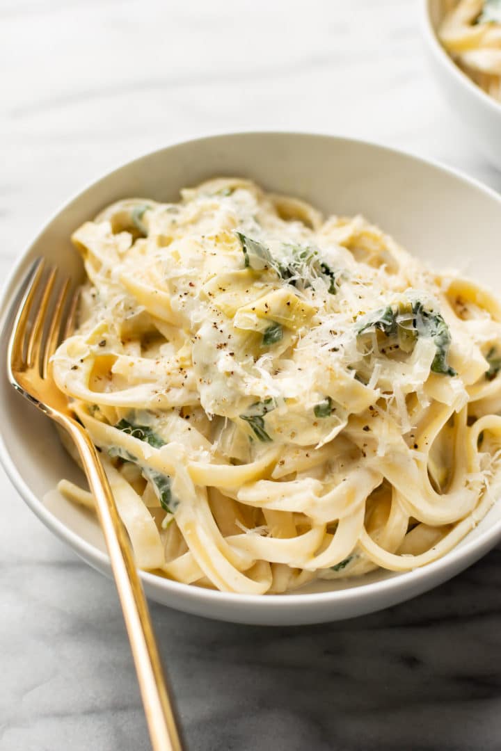 close-up of a bowl of spinach artichoke pasta