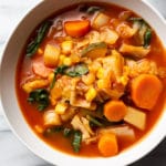 vegetable soup with cabbage in two white bowls