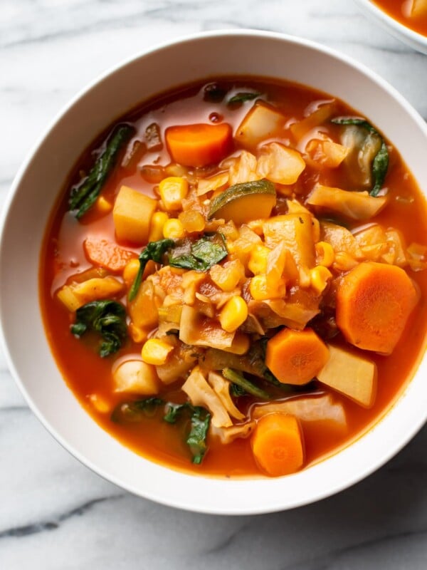 vegetable soup with cabbage in two white bowls