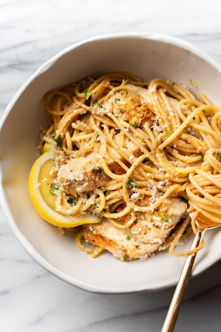 lemon pepper chicken pasta in a white bowl