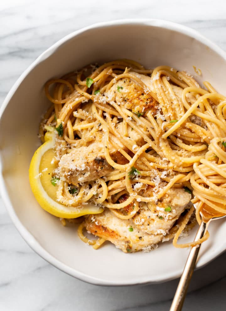 lemon pepper chicken pasta in a white bowl