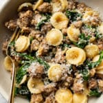 orecchiette pasta with sausage and spinach close-up in a bowl