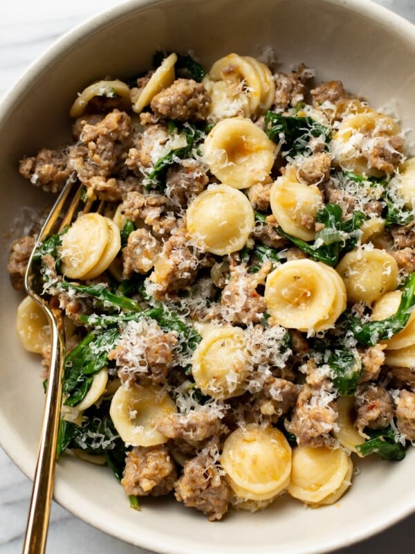 orecchiette pasta with sausage and spinach close-up in a bowl